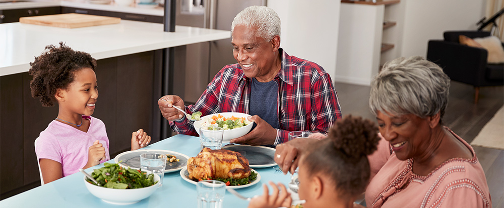 grandparents sitting at kitchen table with grandchildren safe retirement income roseville ca
