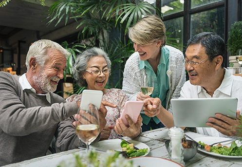 group of laughing senior friends at restaurant reasonable rate of return during retirement roseville ca