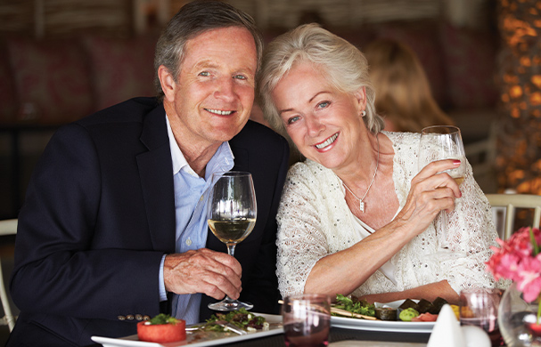 portrait of senior couple smiling at restaurant dinner seminar understanding annuities roseville ca