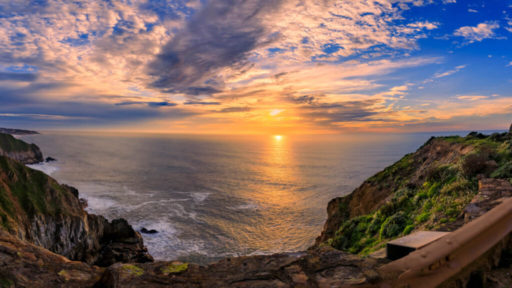 cliff overlooking the ocean at sunset