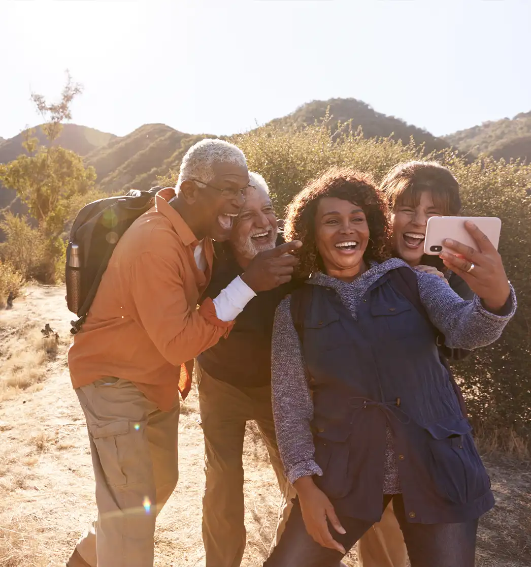 group of senior friends taking a selfie together while hiking simple retirement plan